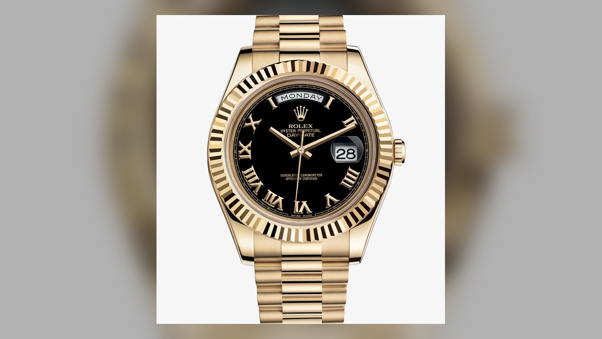 Gold-tone Day-Date style watch illustrating case, bezel and bracelet finish